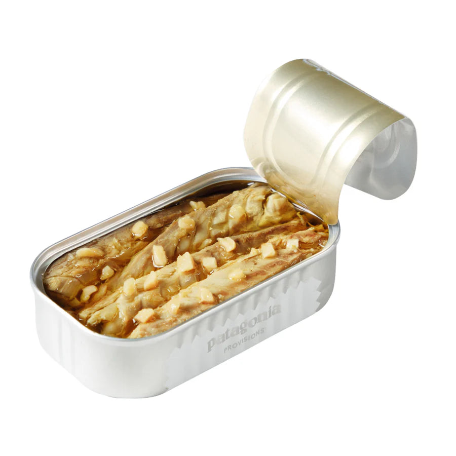 Open can of Patagonia garlic mackerel on a white background