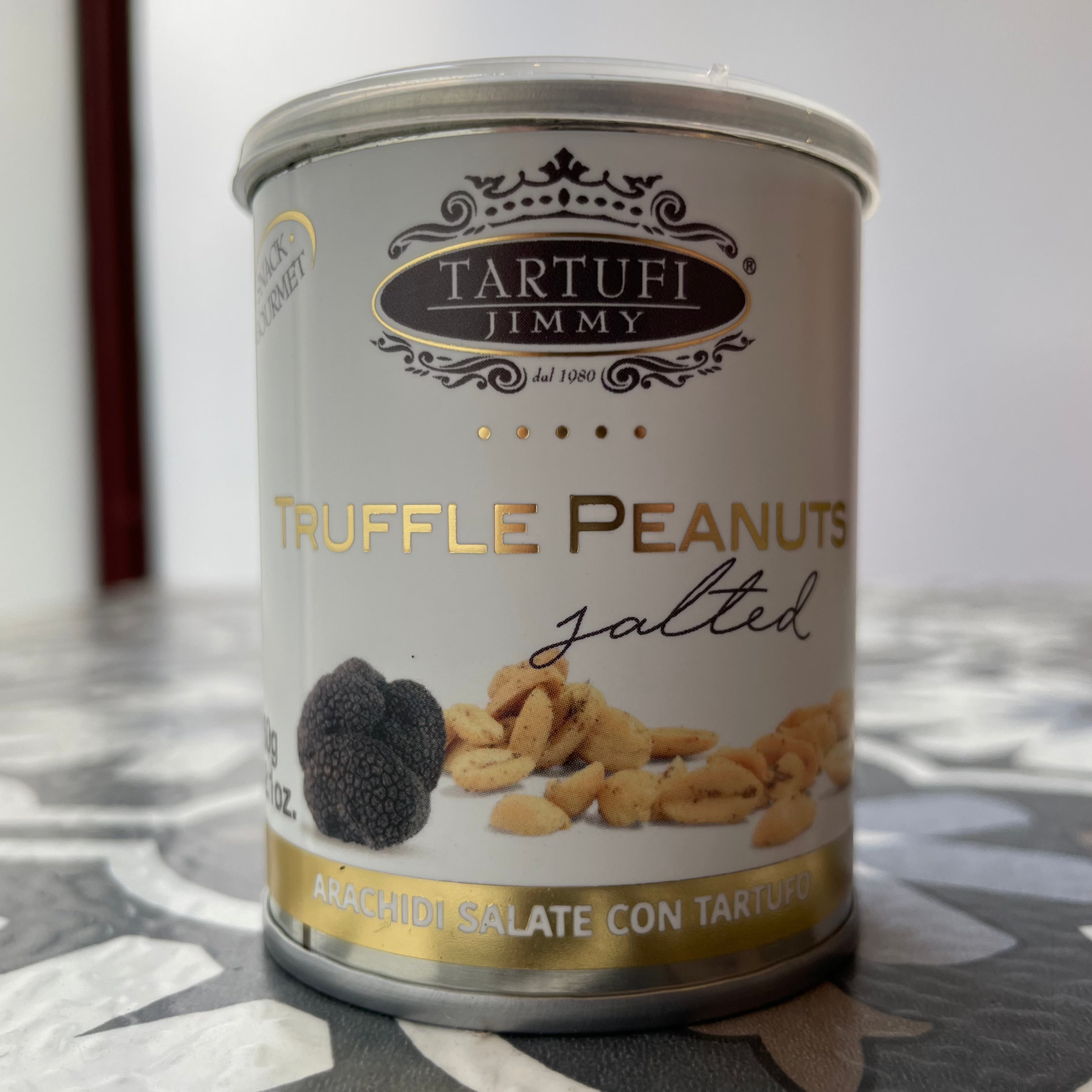 small metal can of truffle peanuts, front side