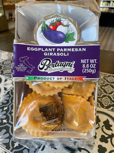 Packaged eggplant parmesan ravioli with Bertagni branding on a patterned surface.