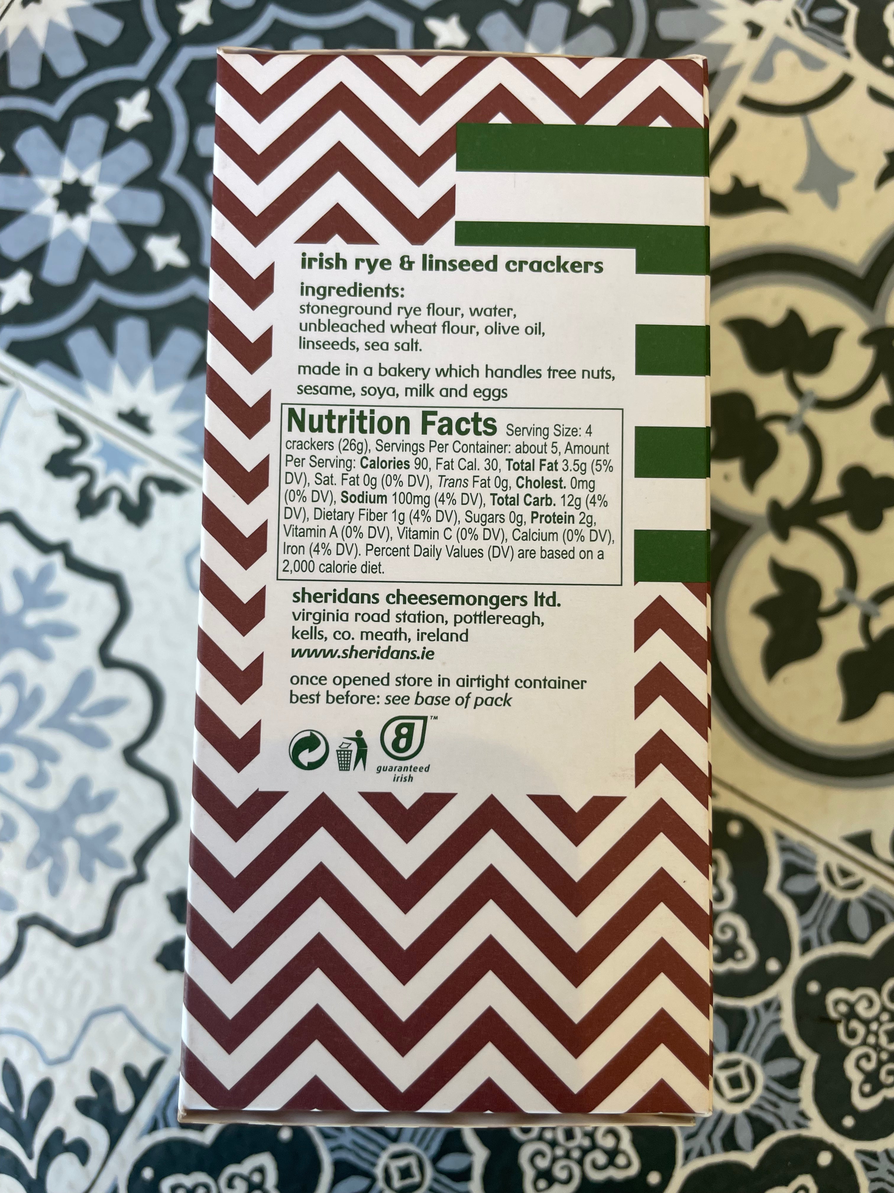 Chevron-patterned crackers packaging with nutrition facts on a patterned surface