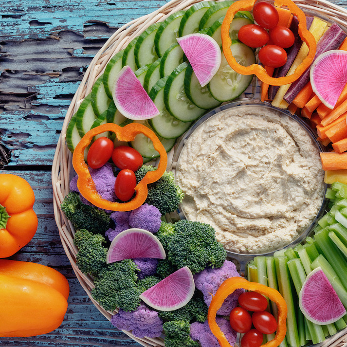 Veggie platter with carrots, celery, cucumber, broccoli, and dip