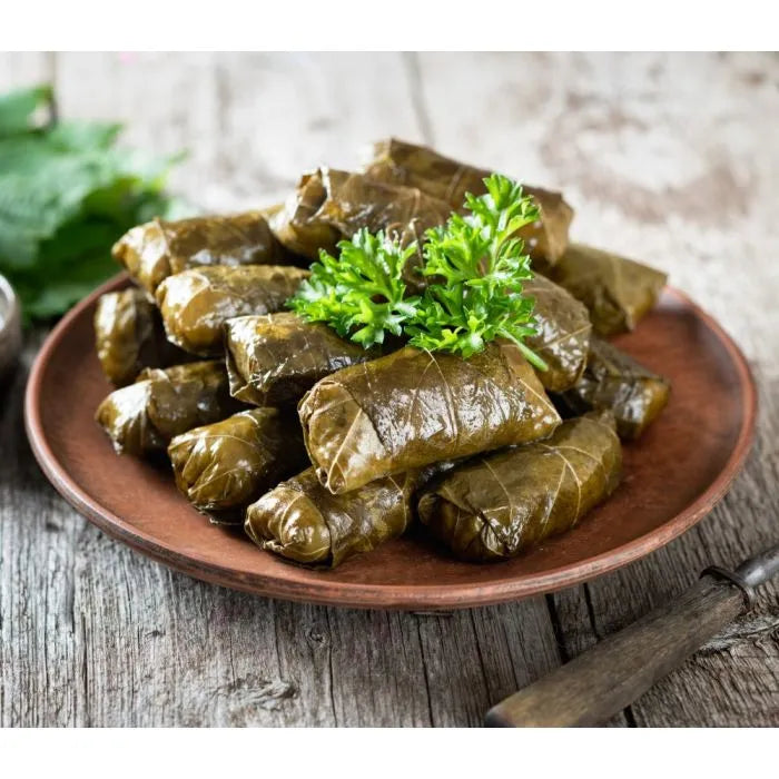 dolmas on a plate, with garnish
