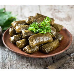 dolmas on a plate, with garnish