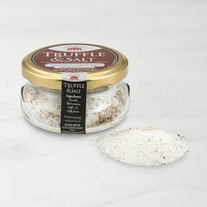 glass jar of truffle salt with salt on the table