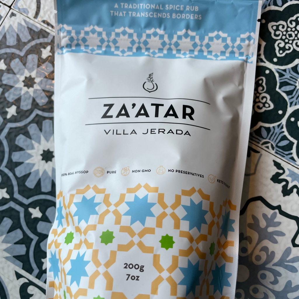 Front side of za'atar 200g bag with patterned design by villa jerada - on patterned background tile