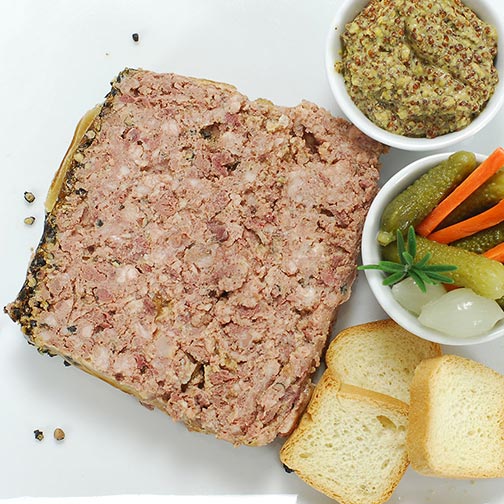slice of pate with cornichons and mustard