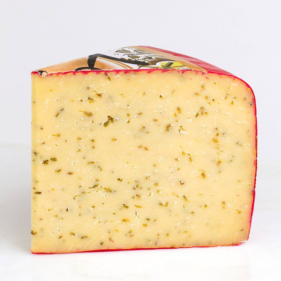 Firm yellow cheese speckled with cumin seeds