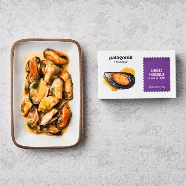 white retail box of smoked mussels, with mussels on a plate with olive oil