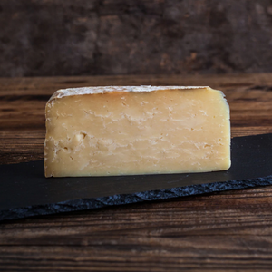 Wedge of crumbly cheddar cheese