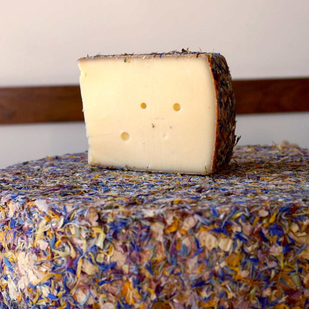 Firm alpine cheese with rind covered in dried wildflowers
