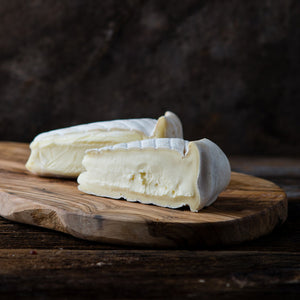 Two wedges of soft brie cheese