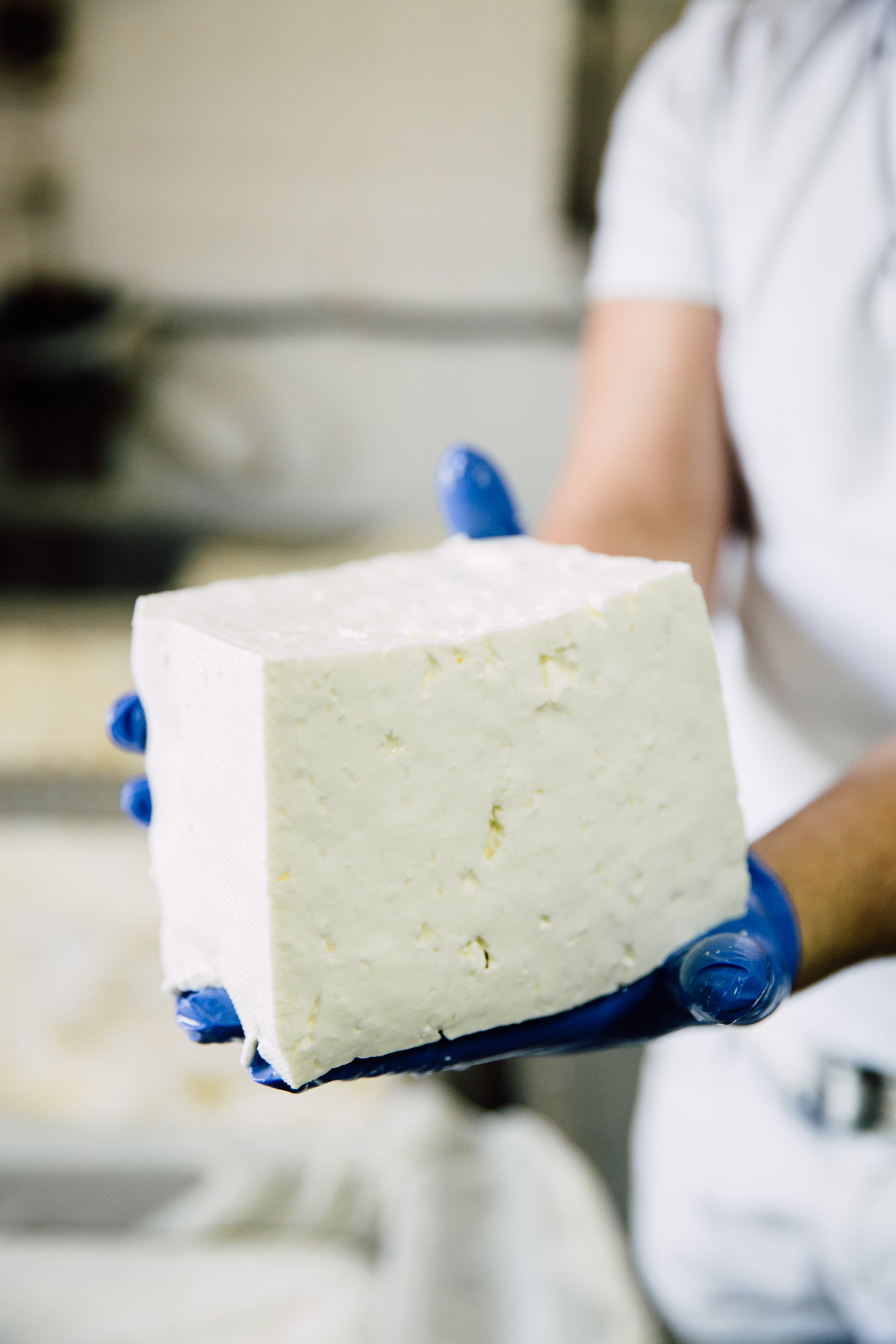 man holding massive block of feta