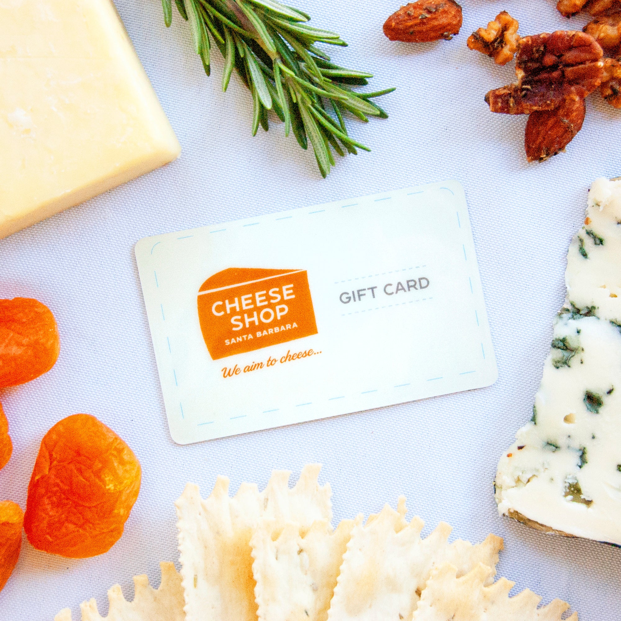 Gift card next to cheese, nuts and fruit