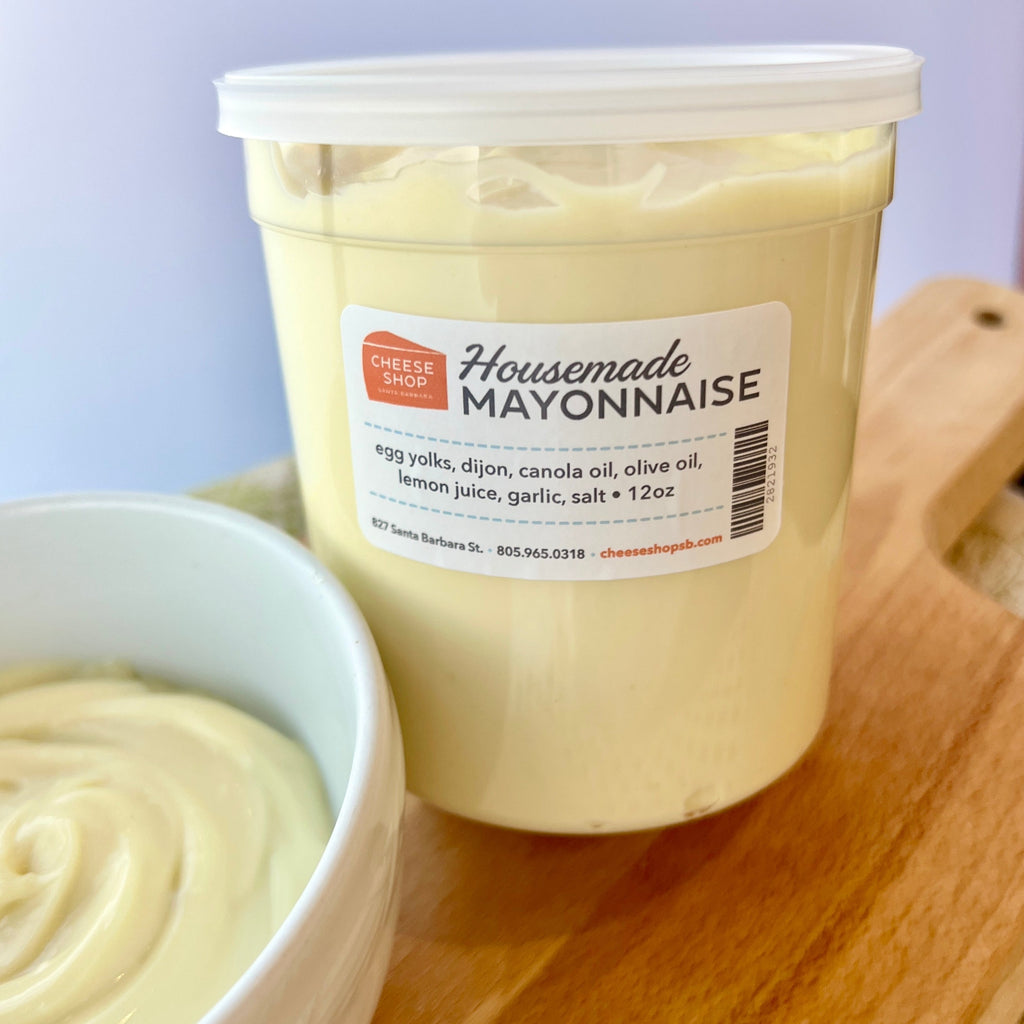 housemade mayonnaise in plastic container with ingredients listed next to bowl of mayonnaise