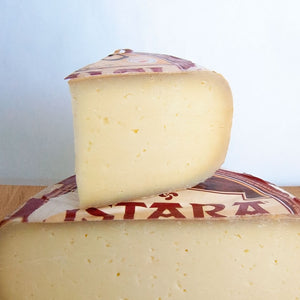 Firm yellow sheep's milk cheese with red and white label